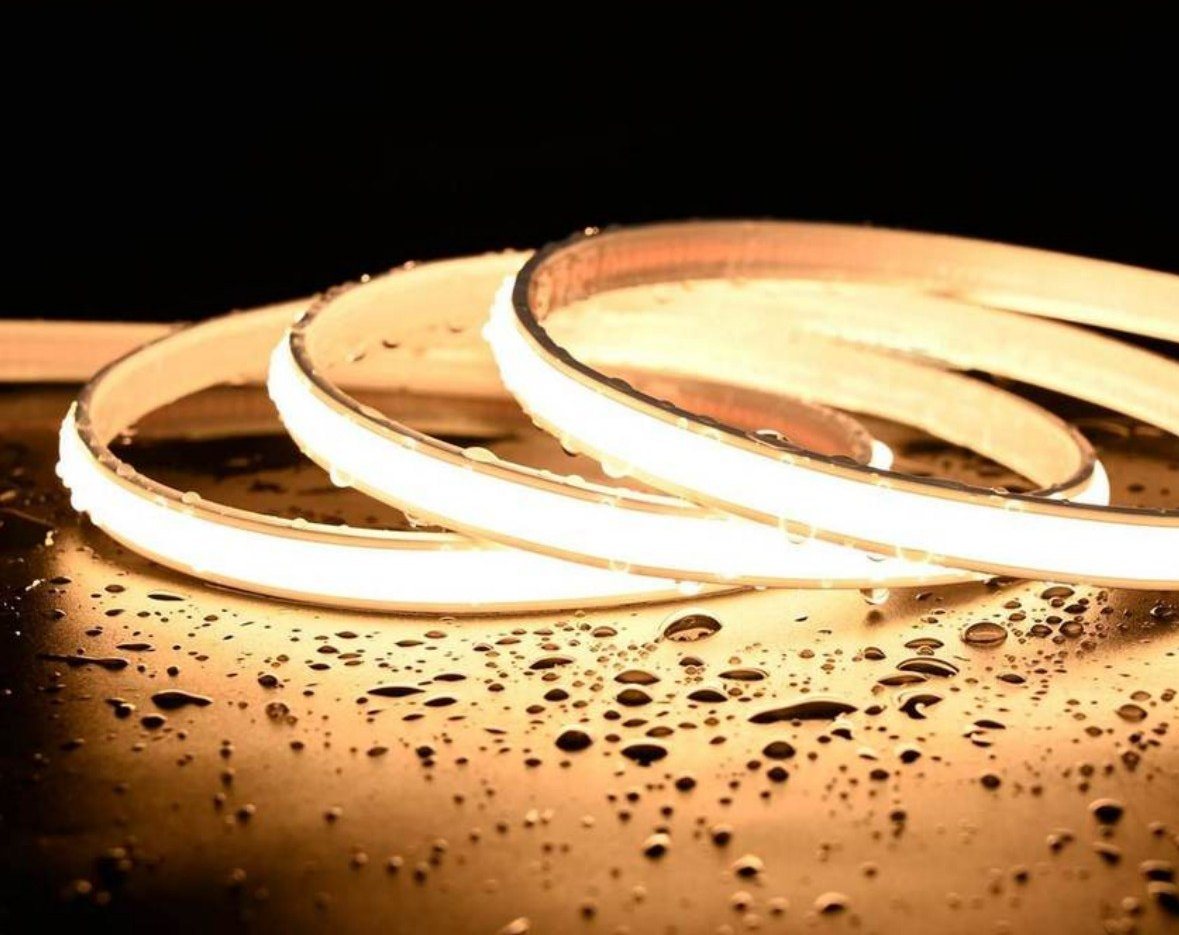 COB neon lit on a surface with water droplets